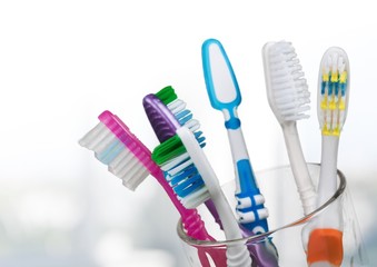 New Colorful Toothbrushes on light Background
