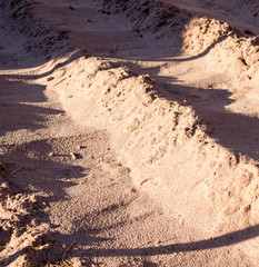 small close-up dunes of beige wet sand. background, nature.