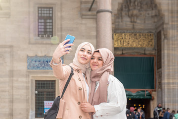 Beautiful Muslim women in fashionable modern trendy clothes
