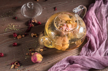 Glass teapot with blooming flower green tea