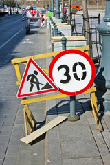 Road signs limit the area of repair and renovation of a street  pedestrian way  in old historical area