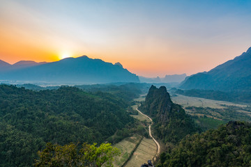 Fototapeta na wymiar Top view of Beautiful Forest landscape of Sunset at pha Namxay Mountains Vang Vieng, Laos