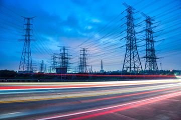 High voltage, high speed road car track in the background of high voltage towers