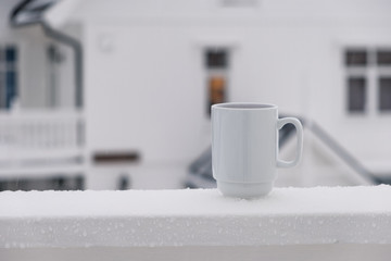 Cranberry juice in white ceramic glass on terrace