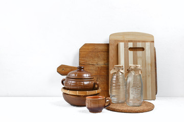 Zero waste concept. Eco-friendly kitchen set A set of wooden boards, earthenware, pot, coffee cups, glass jars for storage. Copy space, light background.