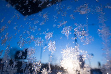 Ice crystals forming on a sheet of glass
