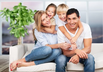 Young  family at home smiling at camera