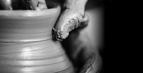 Hands of potter making clay pot, closeup photo