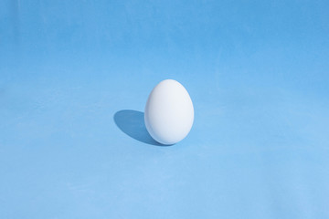  Food background made of white Easter eggs on a blue backdrop