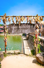 KANCHANABURI PROVINCE, THAILAND - APRIL 16, 2019:  The entrance of Ban E-Tong with wood label tourist, Ban E-Tong, Kanchanaburi, Thailand.