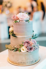 Rustic wedding cake decorated with flowers