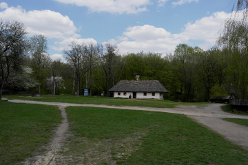  Old ukrainian house.Ukrainian hut of the nineteenth century. Spring landscape, blooming trees.Pirogovo village.