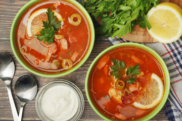 Two bowls with traditional Russian soup solyanka	