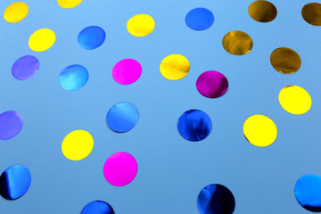 Round confetti on blue background. Festive design. There is a place for text.
