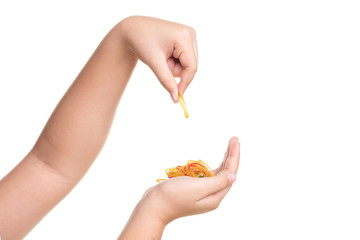 Child hand playing with elastic rubber band isolated on white