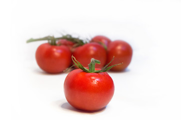 Several cherry tomatoes on white isolated background