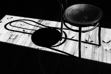 a chair forms a shadow from the sun