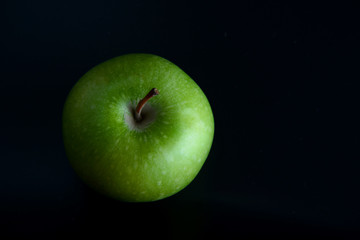 Still life on a black background.Fruit on black background.Apples pears kiwi grapes lemon.Healthy and healthy food. Bright fruit.Healthy diet. Natural food.