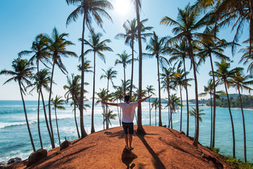 Man on coconut tree hill in Sri Lanka