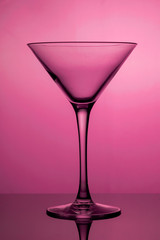 Cocktail glass, the stemmed glass is lit with purple light