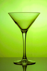 Cocktail glass, the stemmed glass is lit with yellow light