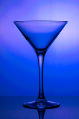 Cocktail glass, the stemmed glass is lit with blue light
