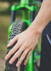 Mountain biker does mechanical check of tyre
