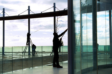 Fototapeta na wymiar workers cleaning glass constructions viewpoint