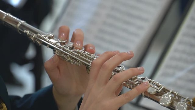 The girl plays the flute. Wind instruments. 4k