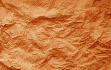 Fototapeta na wymiar Crumpled sheet of paper in orange color.