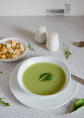 Fresh green Vegetable cream soup. Green Broccoli cream soup on white bolw on the white background