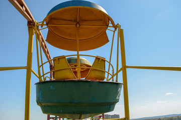 Attraction Cabin Ferris Wheel on the background of the blue sky