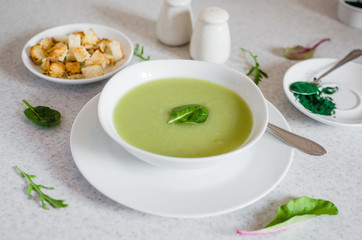 Fresh green Vegetable cream soup. Green Broccoli cream soup on white bolw on the white background