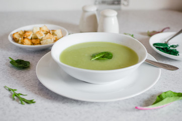 Fresh green Vegetable cream soup. Green Broccoli cream soup on white bolw on the white background