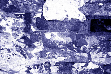 Old grungy brick wall texture in blue tone.