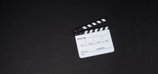 White Clapperboard or clap board or movie slate on black background. It's use in video production ,...