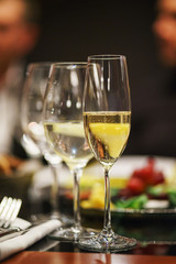 transparent wine glasses with drinks on a table in a bar or restaurant prepared for guests of festive events