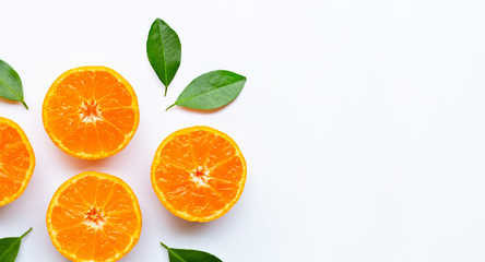 Orange fruits with  leaves on white background.