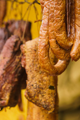 Smoked sausages meat hanging in smokehouse