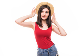 Portrait of an excited young girl in summer hat and clothes looking at copy space over white background
