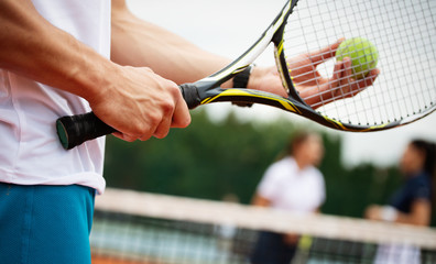 Fit happy poeple playing tennis together. Sport concept