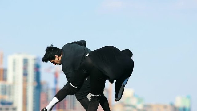 Young men doing acrobatic tricks in the air. Performing overbah