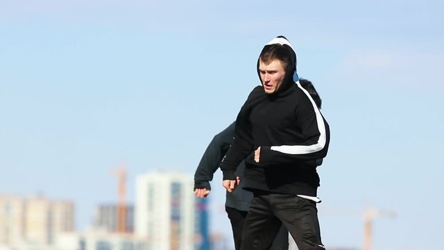 Three young men doing acrobatic tricks in the air. Performing overbah