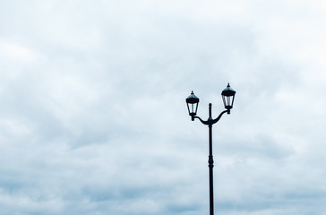 Street lamp against a cloudy sky.