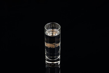 A coctail from vodka on black background. studio shot
