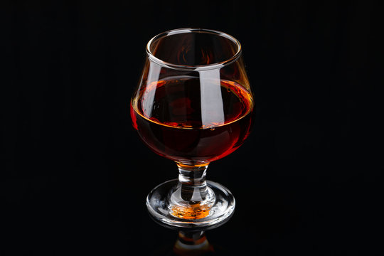 Glass of brandy on a black background