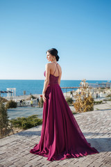 Beautiful woman in elegant evening dress. Beautiful young woman, model, in an evening dress outdoors.A portrait of a beautiful elegant woman in the evening dress. Fashion, evening dresses for events.