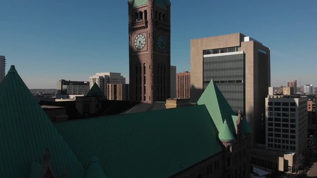 Aerial footage of building with a clock at downtown minneapolis
