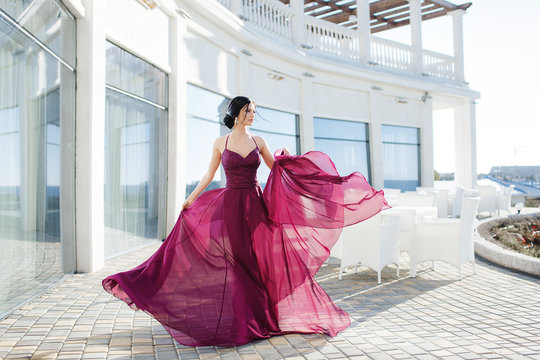 Beautiful woman in elegant evening dress. Beautiful young woman, model, in an evening dress outdoors.A portrait of a beautiful elegant woman in the evening dress. Fashion, evening dresses for events.