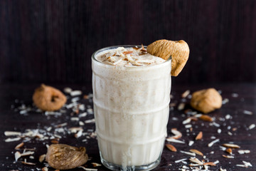 Anjeer milk shake or dried fig milk shake with almonds - selective focus